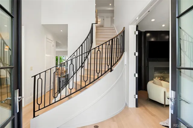 a view of a hallway with livingroom and furniture