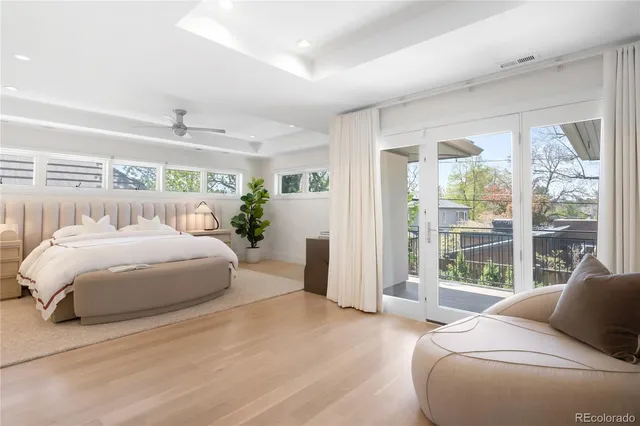 a spacious bedroom with a large bed and a large window