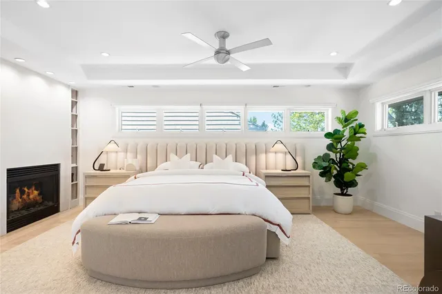 a spacious bedroom with a bed and a potted plant