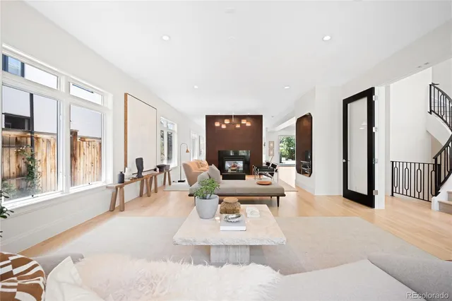 a living room with furniture large window and a table