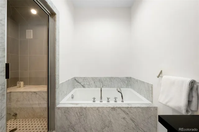 a bedroom with a bed and a chair