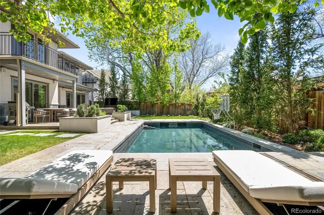 a view of swimming pool with sitting area and garden