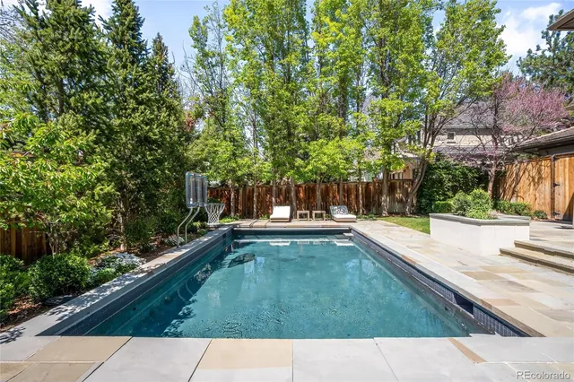 a living room with a large window and furniture