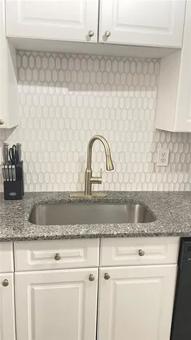 a kitchen with sink refrigerator and stove