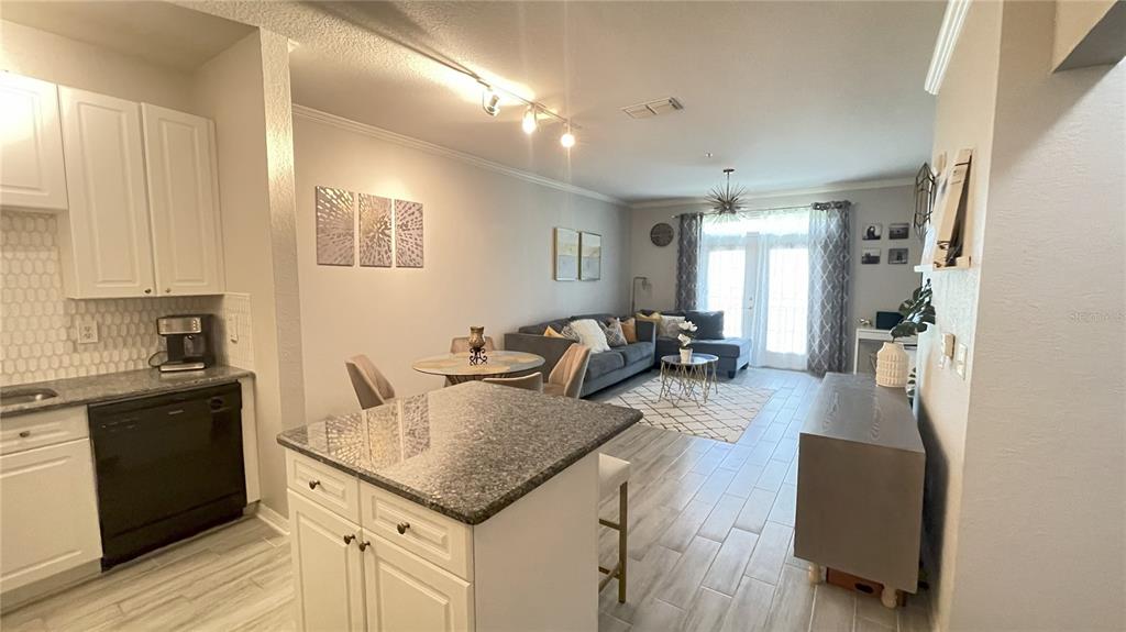 4221 West Spruce Street, Unit 1107 Tampa, FL 33607 - Photo 13 of 23 a kitchen with sink refrigerator and stove