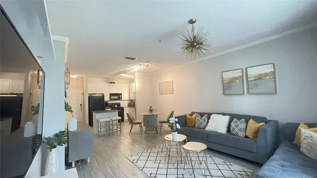 a living room with furniture and a chandelier