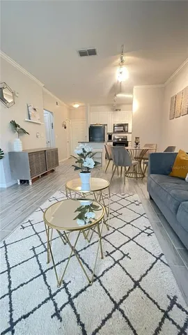 a kitchen with stainless steel appliances a sink a stove a microwave a sink a refrigerator and cabinets