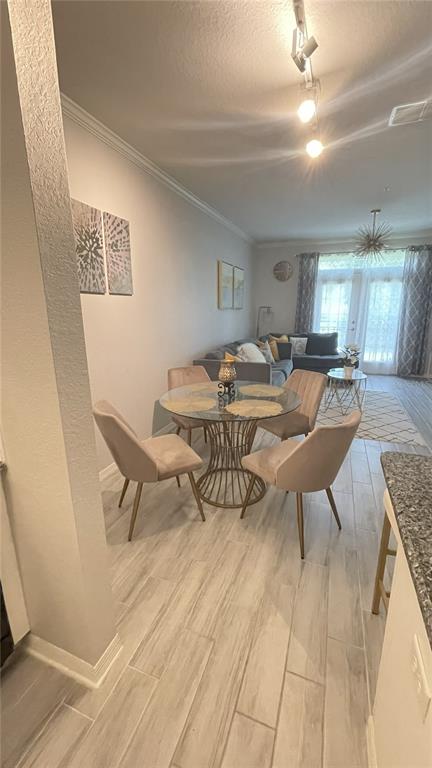 4221 West Spruce Street, Unit 1107 Tampa, FL 33607 - Photo 18 of 23 a living room with furniture and a chandelier