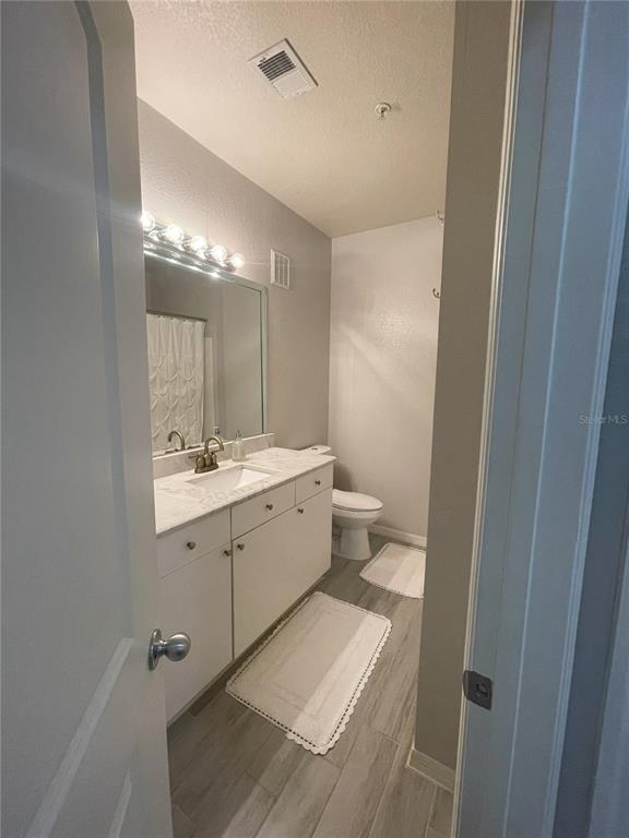 4221 West Spruce Street, Unit 1107 Tampa, FL 33607 - Photo 20 of 23 a bathroom with a double vanity sink mirror and toilet