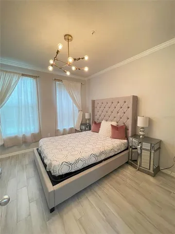 a spacious bedroom with a bed and window