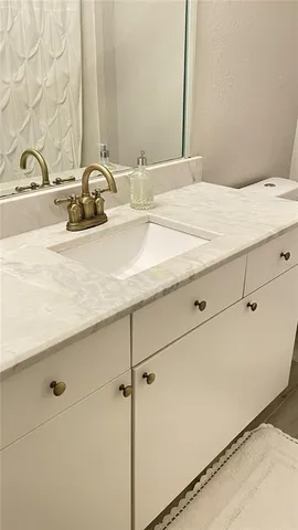 a bathroom with a double vanity sink and mirror