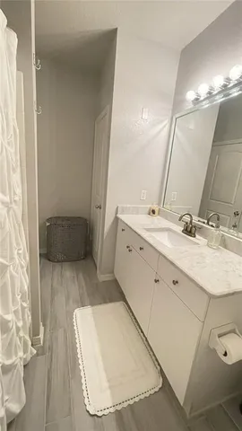 a bathroom with a sink a mirror and a shower