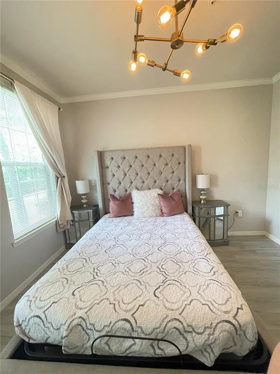 4221 West Spruce Street, Unit 1107 Tampa, FL 33607 - Photo 3 of 23 a bed sitting in a bedroom next to a window