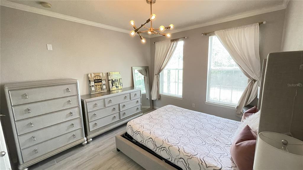 4221 West Spruce Street, Unit 1107 Tampa, FL 33607 - Photo 5 of 23 a spacious bedroom with a bed and window