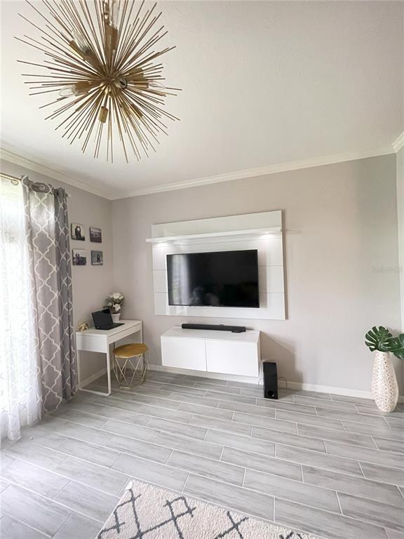 4221 West Spruce Street, Unit 1107 Tampa, FL 33607 - Photo 6 of 23 a living room with furniture and a flat screen tv