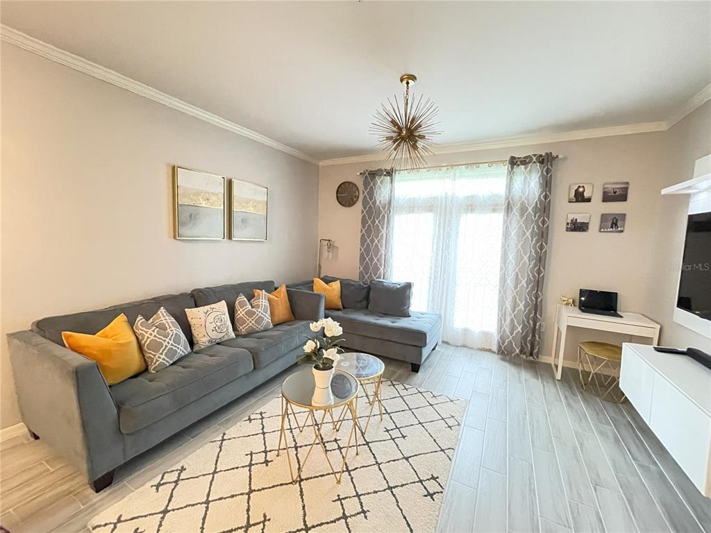 4221 West Spruce Street, Unit 1107 Tampa, FL 33607 - Photo 7 of 23 a living room with furniture and wooden floor