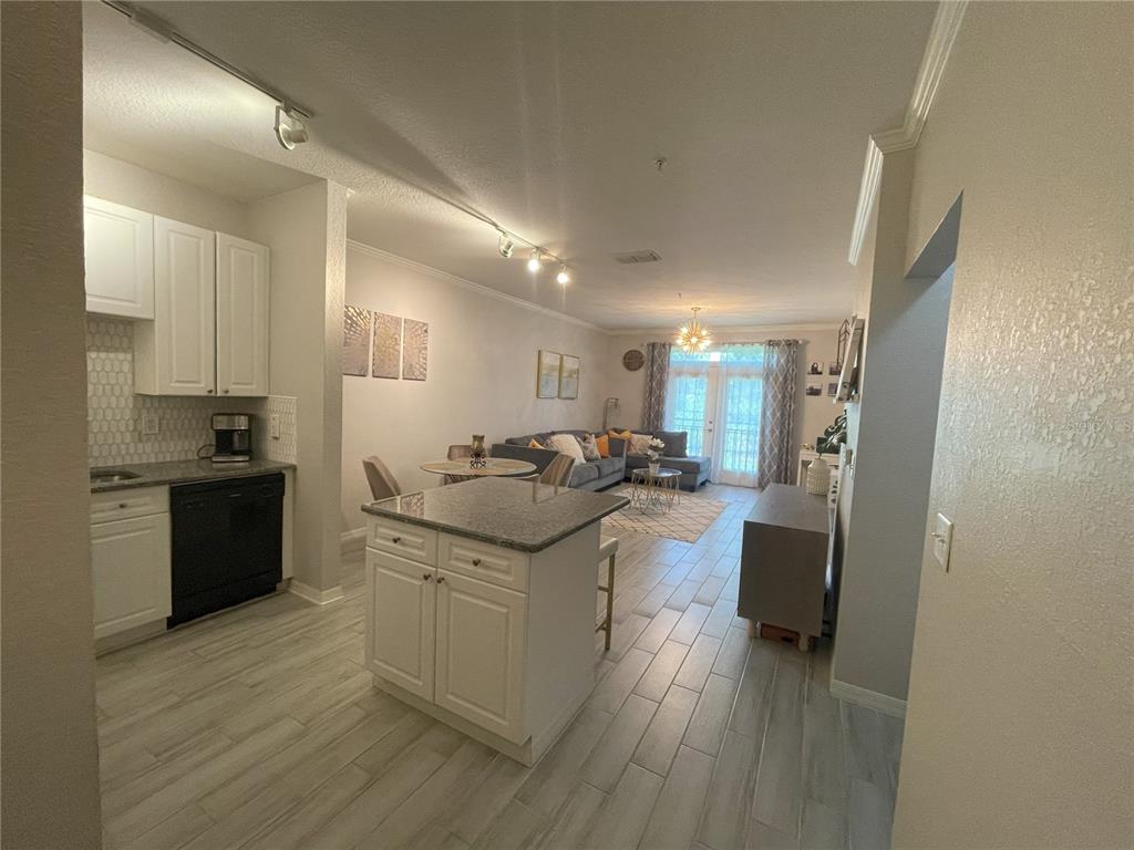 4221 West Spruce Street, Unit 1107 Tampa, FL 33607 - Photo 10 of 23 a kitchen with stainless steel appliances granite countertop a sink stove and refrigerator