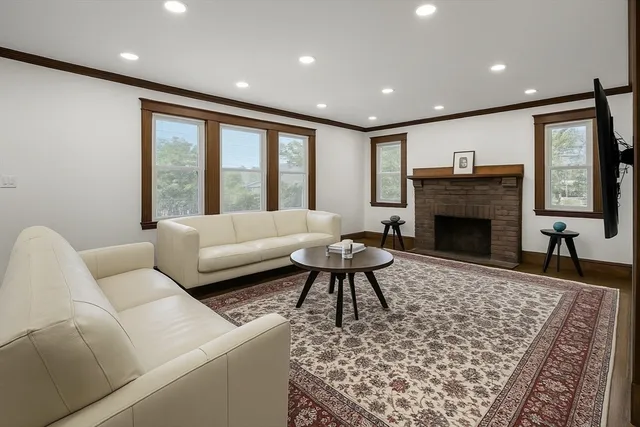a living room with furniture and a fireplace
