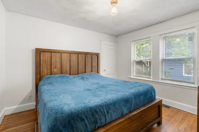 a bedroom with a bed and window