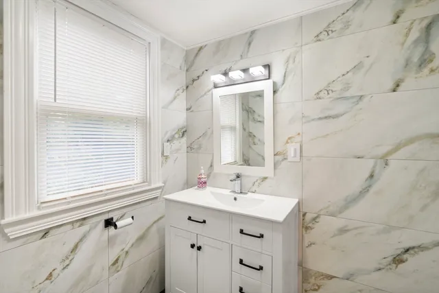a bathroom with a sink vanity and a mirror