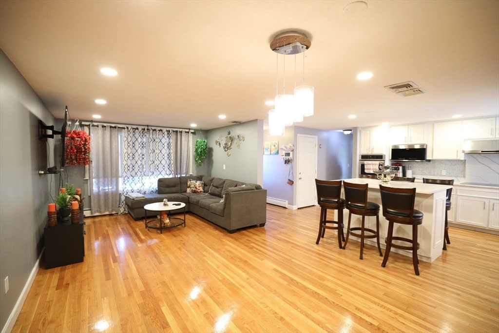a living room with furniture and kitchen view