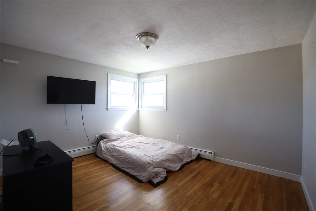45 Assunta Road Revere, MA 02151 - Photo 11 of 19 a bedroom with a bed and a flat tv screen on the dresser