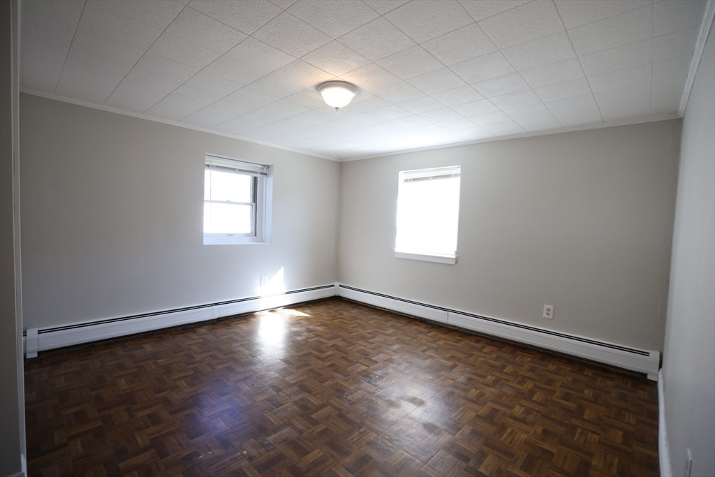 45 Assunta Road Revere, MA 02151 - Photo 15 of 19 an empty room with wooden floor and windows
