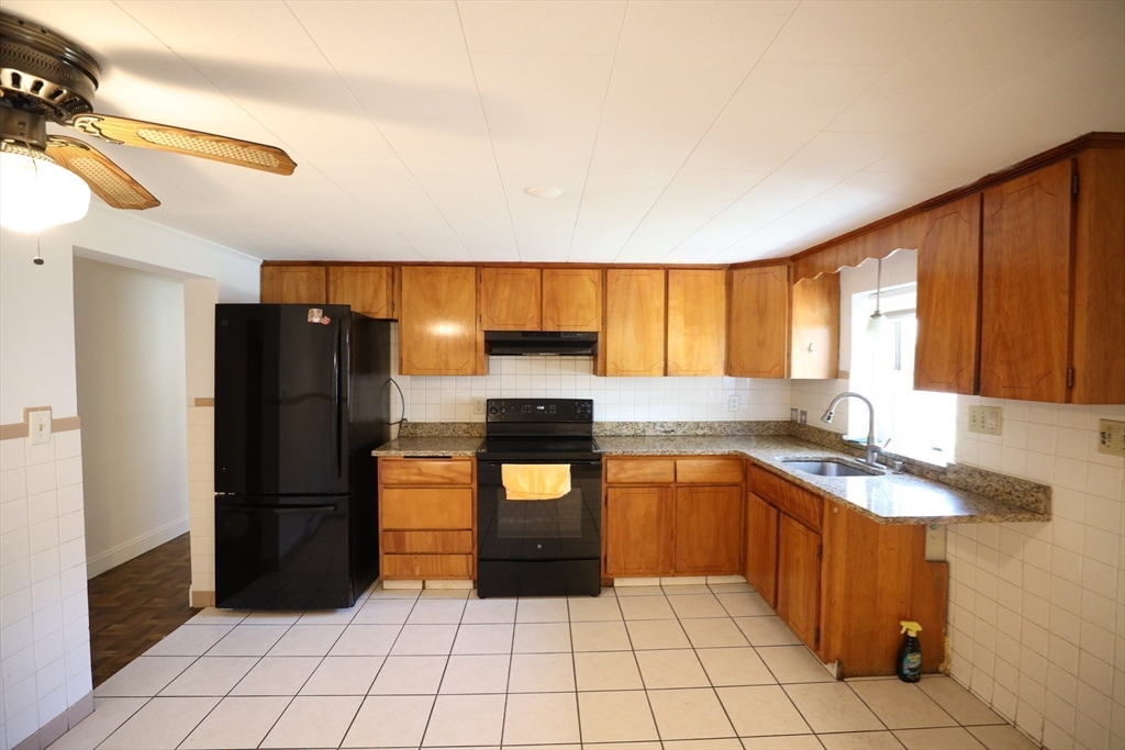 45 Assunta Road Revere, MA 02151 - Photo 16 of 19 a kitchen with stainless steel appliances granite countertop a refrigerator and a sink