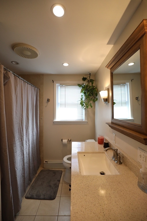 45 Assunta Road Revere, MA 02151 - Photo 9 of 19 a bathroom with a tub sink and mirror