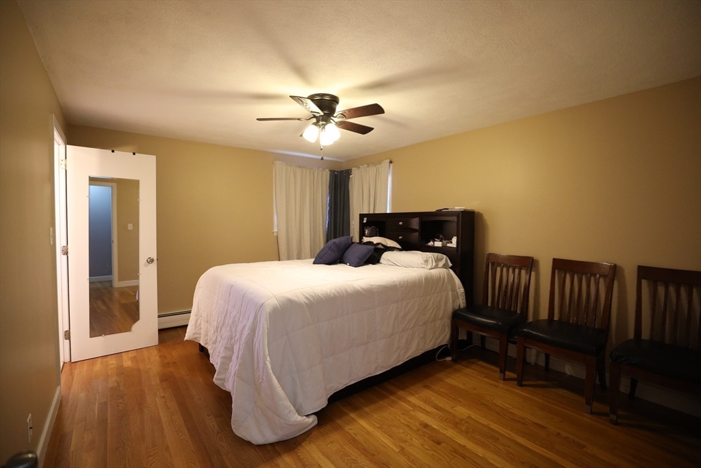 45 Assunta Road Revere, MA 02151 - Photo 10 of 19 a bedroom with a bed and wooden floor