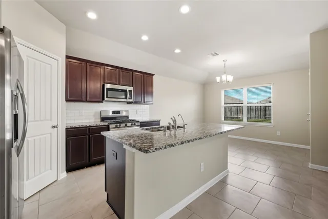 a kitchen with a sink stove and refrigerator