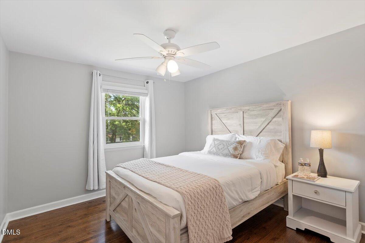 2120 Hillock Drive Raleigh, NC 27612 - Photo 21 of 29 a bedroom with a bed and a chandelier
