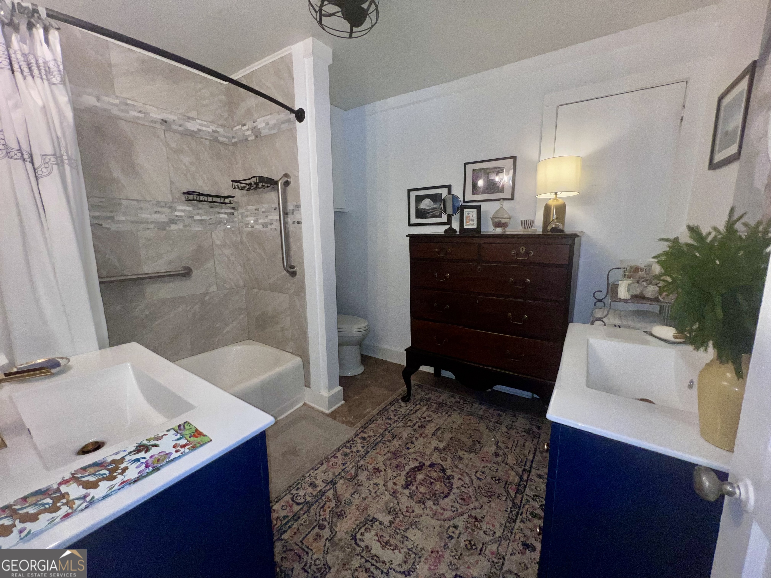 600 Foster Street Madison, GA 30650 - Photo 26 of 54 a bathroom with a tub shower vanity and a sink