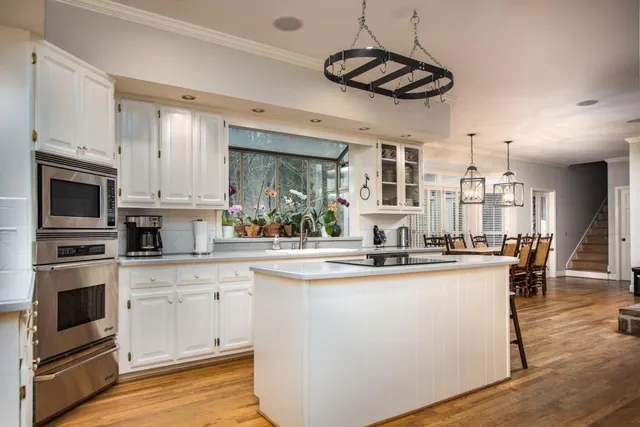 a kitchen with stainless steel appliances a sink stove and refrigerator