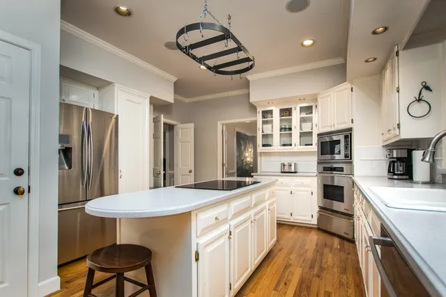 a spacious bedroom with a bed and a dresser