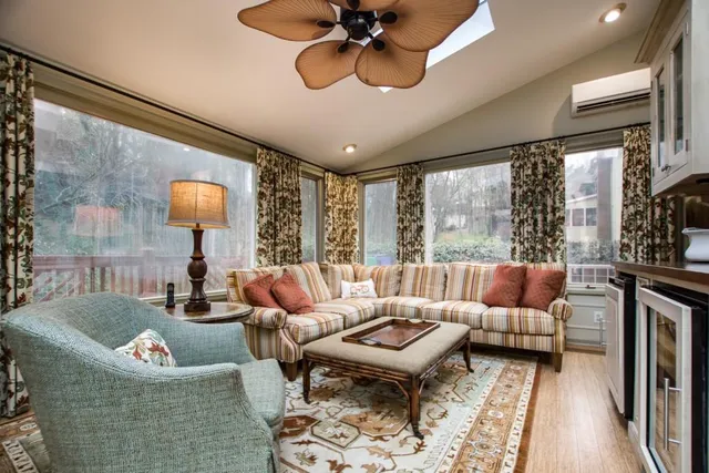 a living room with furniture a flat screen tv and kitchen view