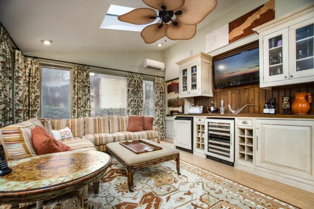 a balcony with wooden floor table and chairs