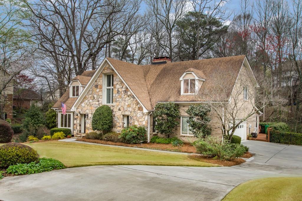 1106 Byrnwyck Road Northeast Brookhaven, GA 30319 - Photo 2 of 41 a front view of a house with a yard and trees