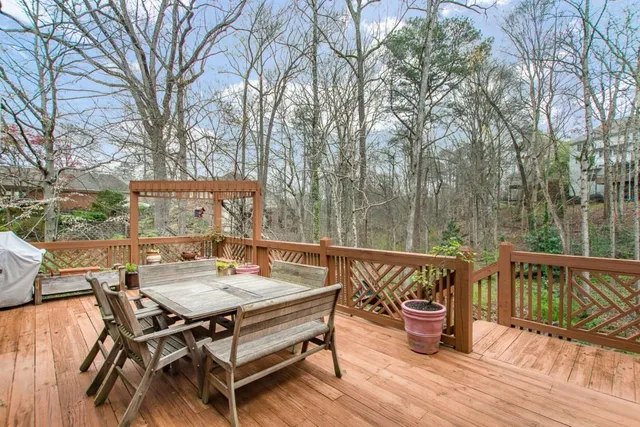 a view of a wooden chairs and table in the deck