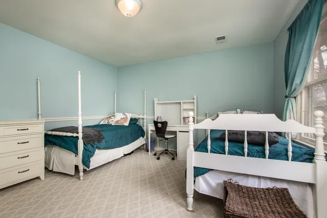 a living room with a bed furniture and a large window