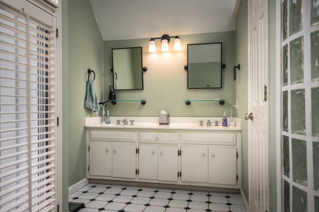 1106 Byrnwyck Road Northeast Brookhaven, GA 30319 - Photo 34 of 41 a bathroom with a sink a toilet and mirror
