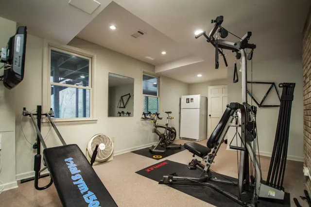 a living room with furniture a computer on desk and chair
