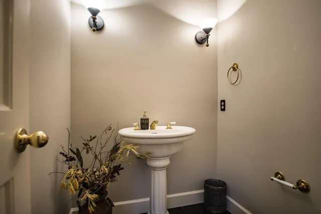 a living room with furniture a fireplace and a large window