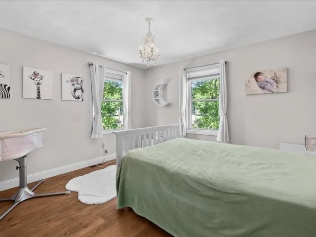 a spacious bedroom with a bed and a window