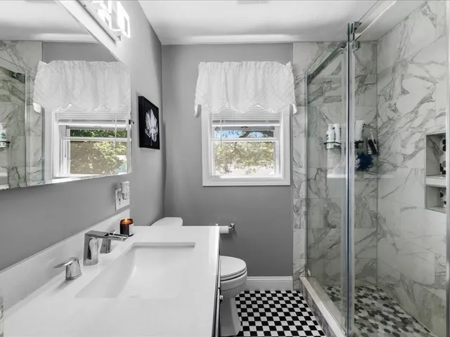 a bathroom with a sink toilet and shower
