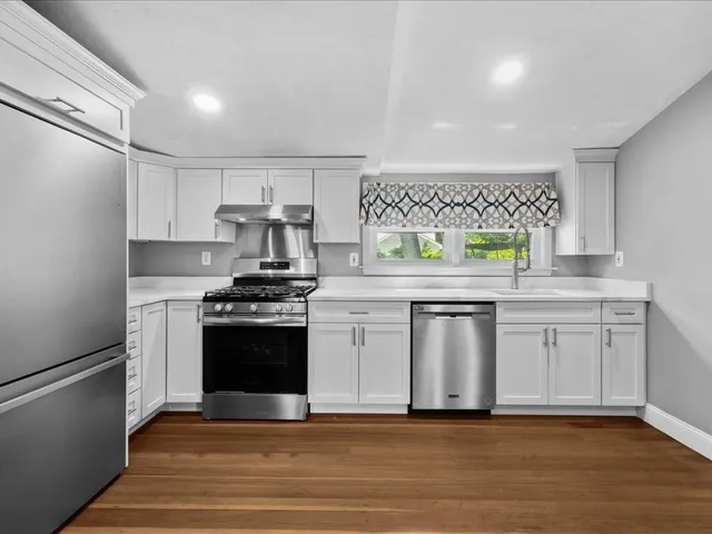 a kitchen with stainless steel appliances granite countertop a stove and a sink