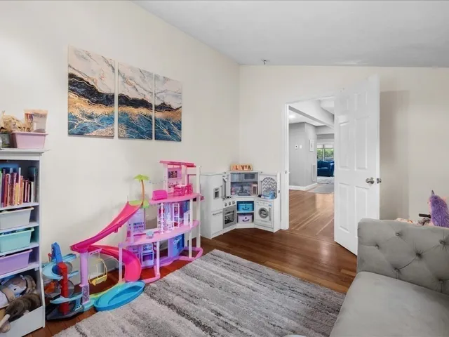 a living room with furniture and a book shelf