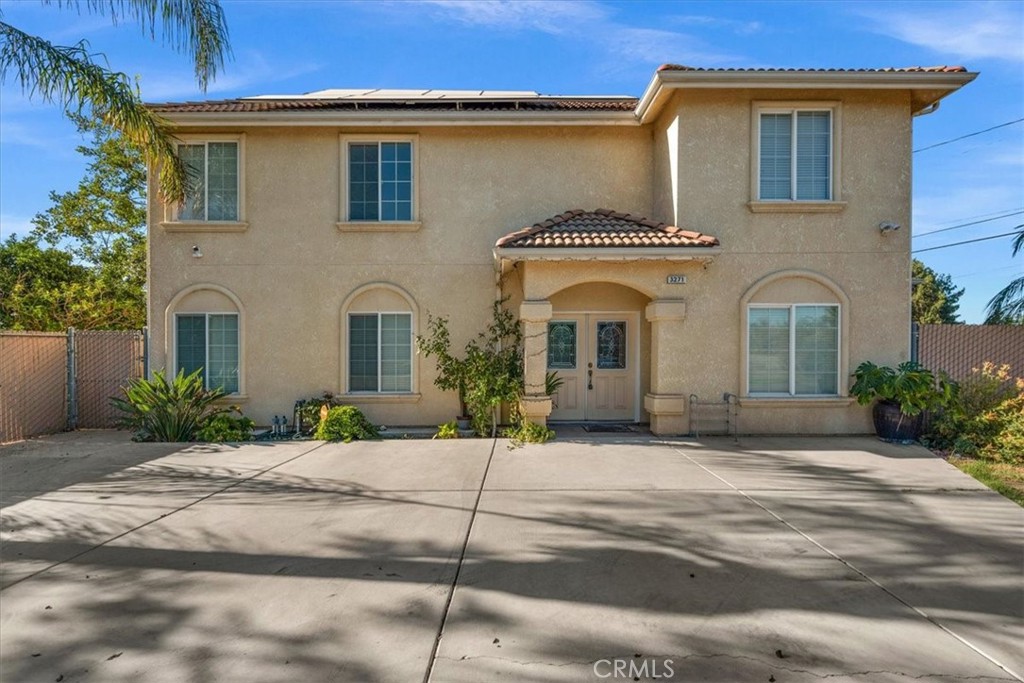 3271 East Muscat Avenue Fresno, CA 93725 - Photo 1 of 53 a front view of a house with a yard