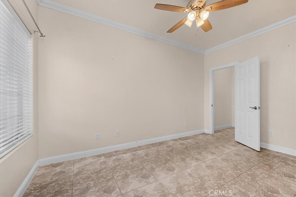 3271 East Muscat Avenue Fresno, CA 93725 - Photo 14 of 53 an empty room with a chandelier fan and a table