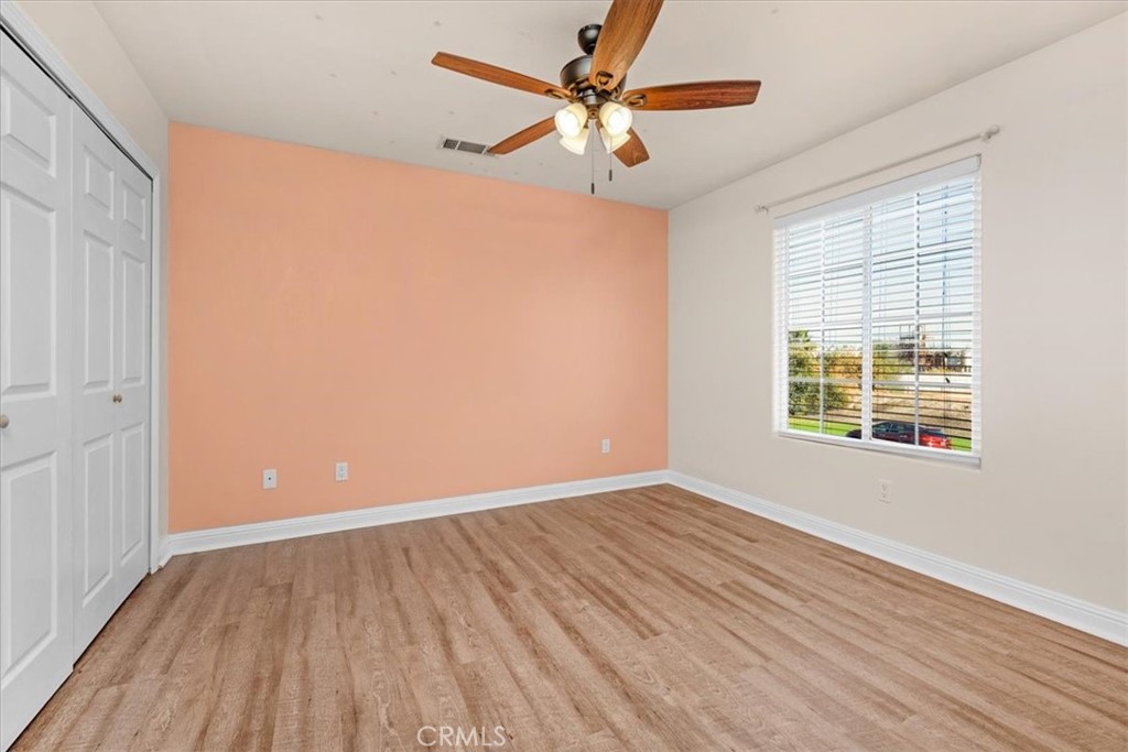 3271 East Muscat Avenue Fresno, CA 93725 - Photo 24 of 53 a view of an empty room with wooden floor and a window